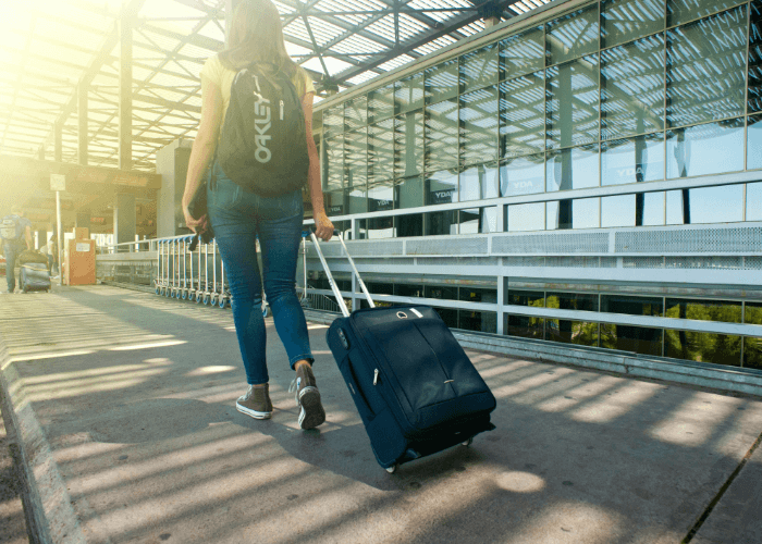 Person carrying luggage through airport